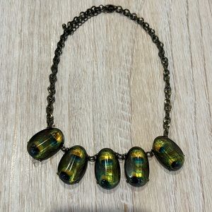 Necklace with peacock feather design in baubles